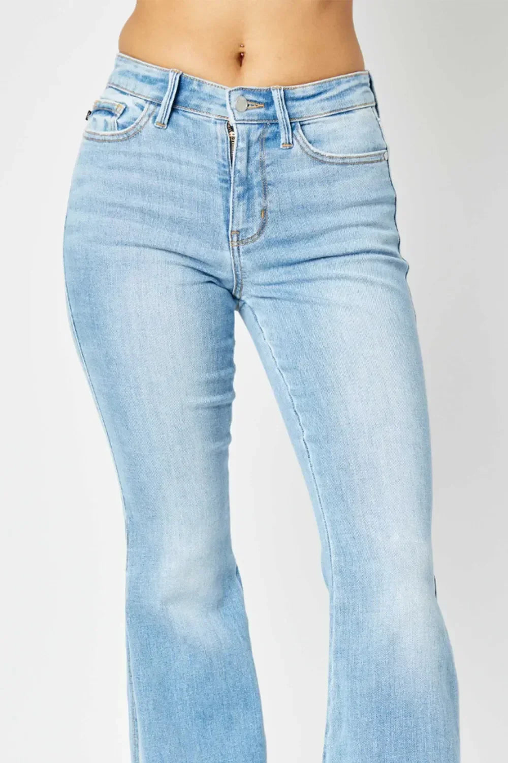 High-rise light wash bootcut jeans with classic five-pocket styling on model.