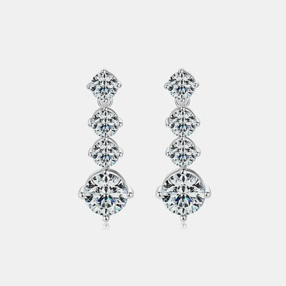 Elegant silver drop earrings with four round, graduated cubic zirconia stones on white background.