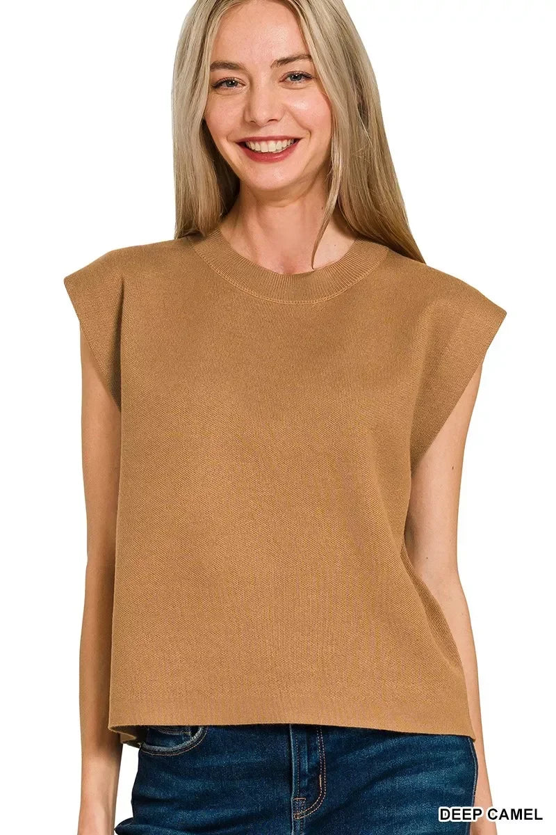 Woman wearing sleeveless deep camel knit top with relaxed fit and crew neckline