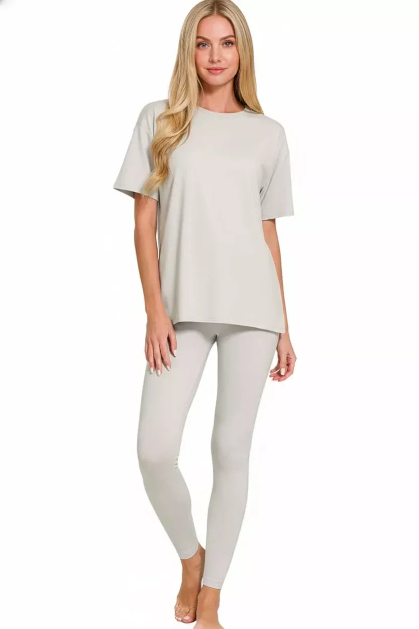 Woman wearing light grey lounge set with short sleeve top and matching leggings