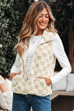 Woman wearing a cream checkered faux fur vest over a white long sleeve top and blue jeans outdoors